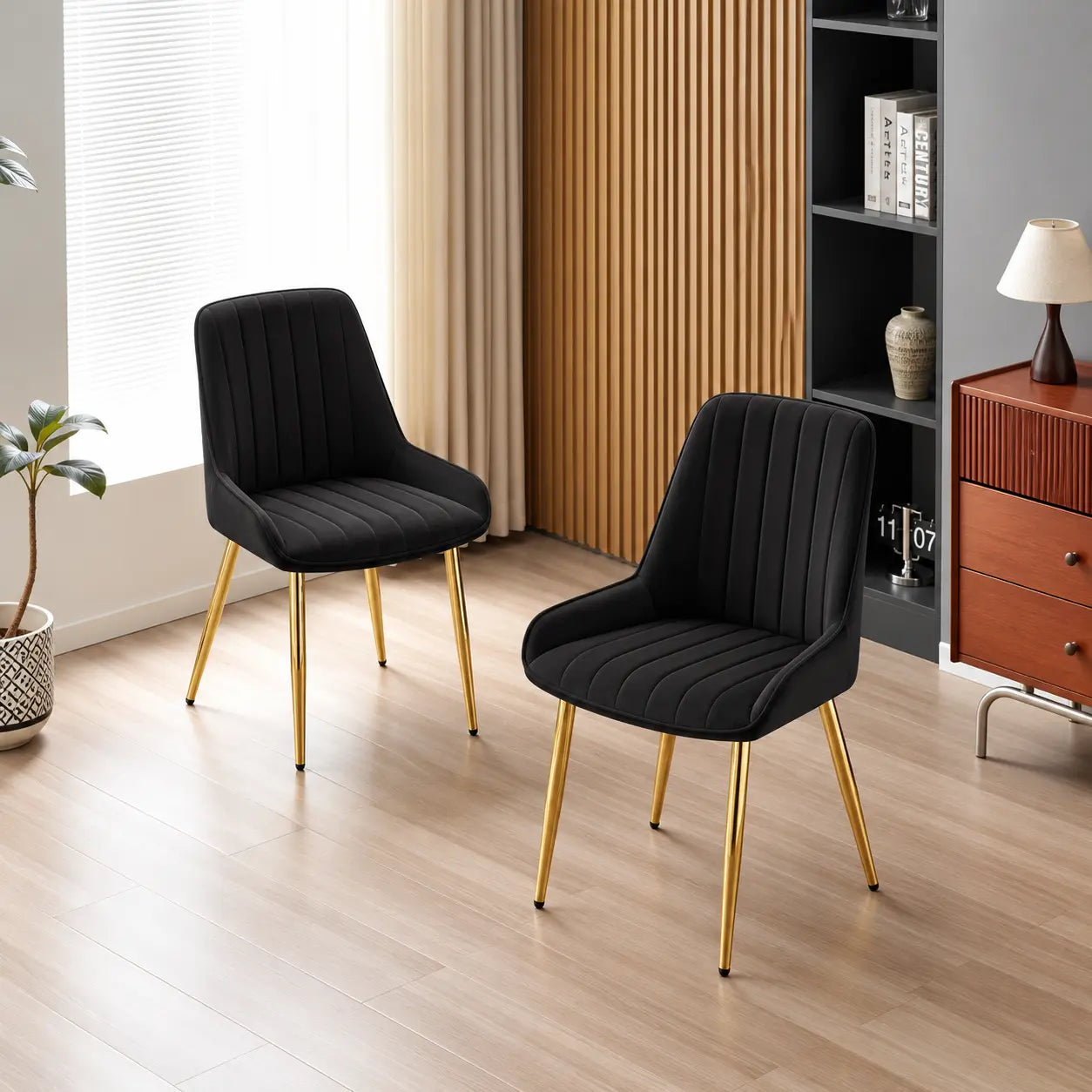 Deux chaises en velours noir avec des pieds dorés, au design élégant et moderne, ajoutent une touche sophistiquée à votre.